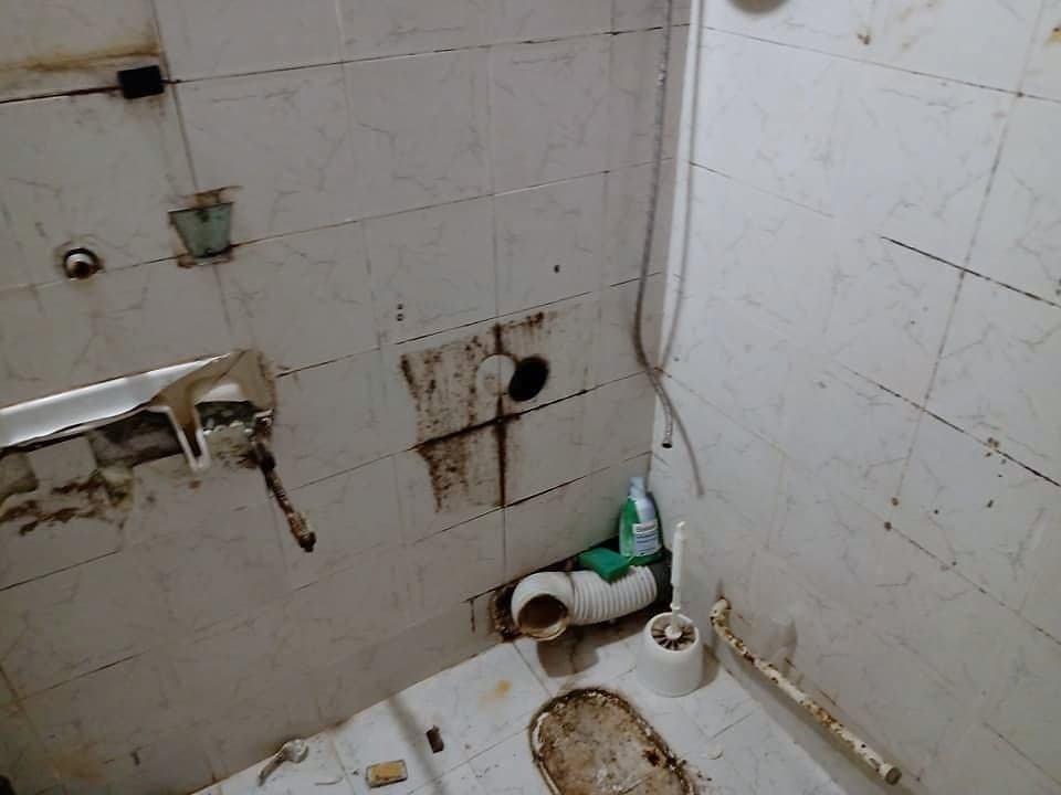 Bathroom with a shower enclosure and a wall-hung toilet — Before the renovation
