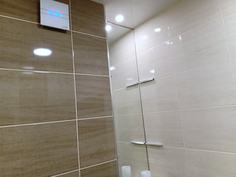 Beige and brown bathroom with a shower enclosure — Glass shower enclosure