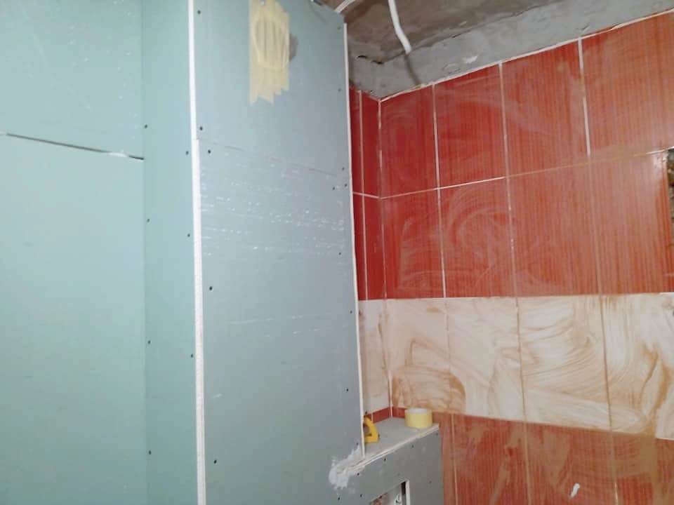 Beige and brown bathroom with a shower enclosure — During the renovation: moisture-resistant plasterboard over the old tiles