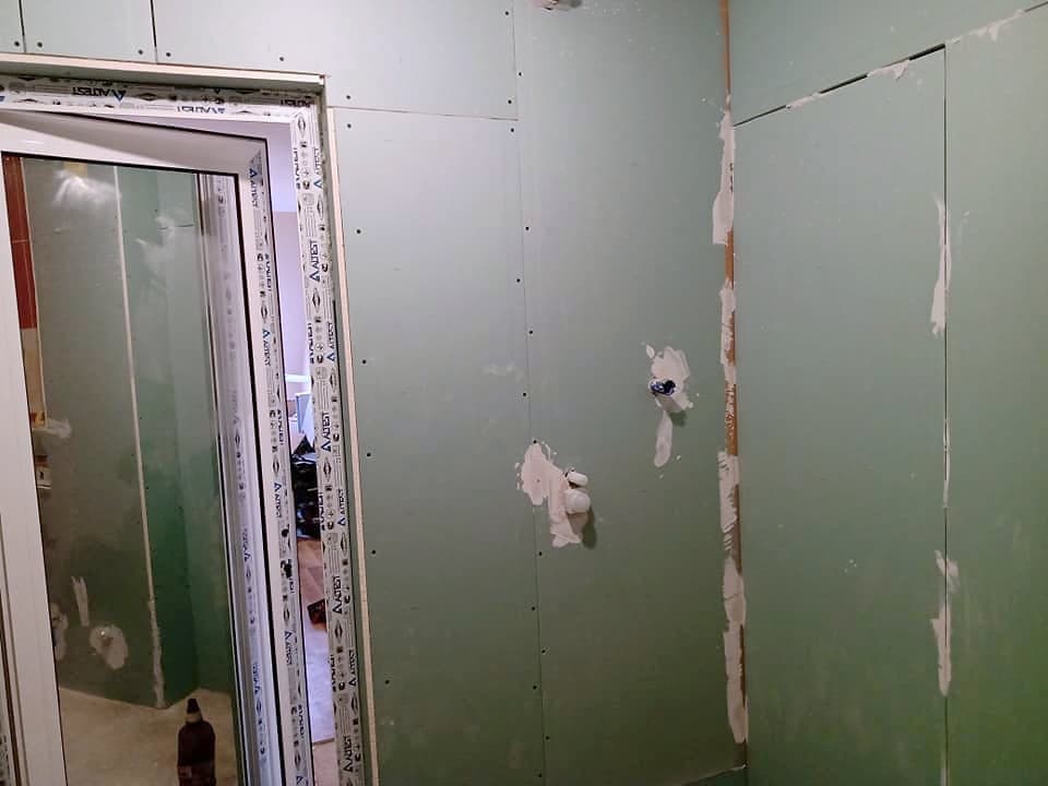 Beige and brown bathroom with a shower enclosure — During the renovation: moisture-resistant plasterboard lining