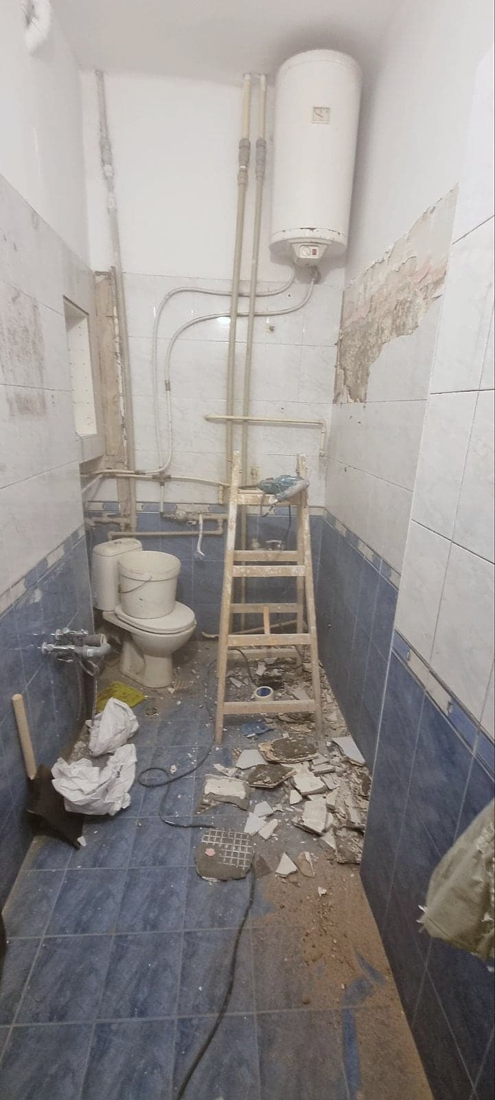 White and grey marble bathroom with black taps — The bathroom before and after the renovation