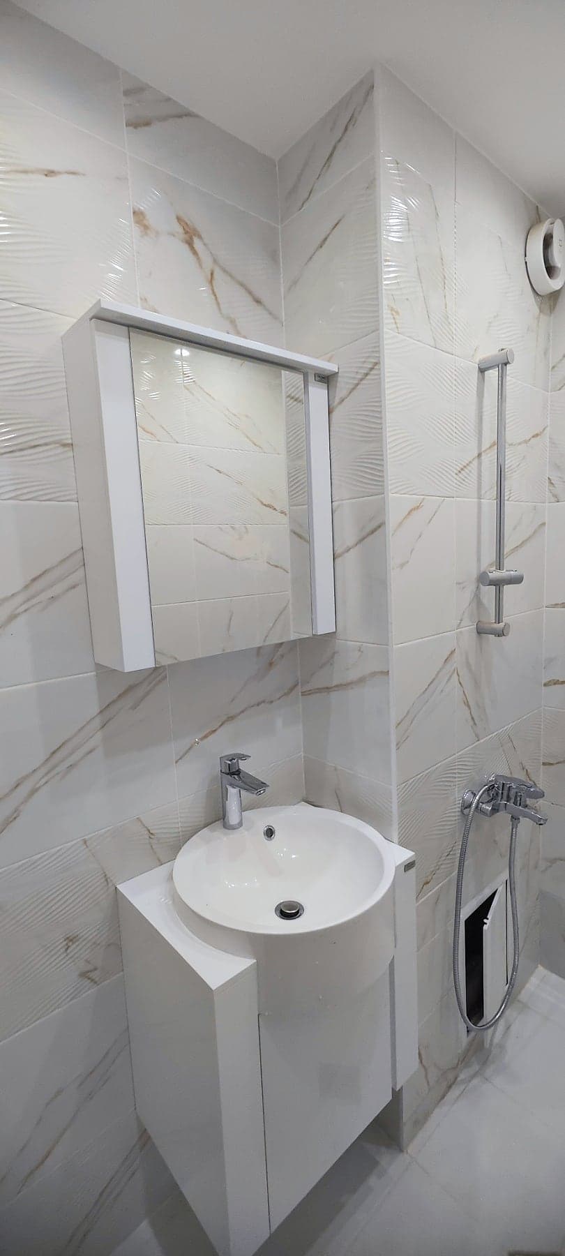 White marble bathroom with a round basin — Round basin and mirror cabinet