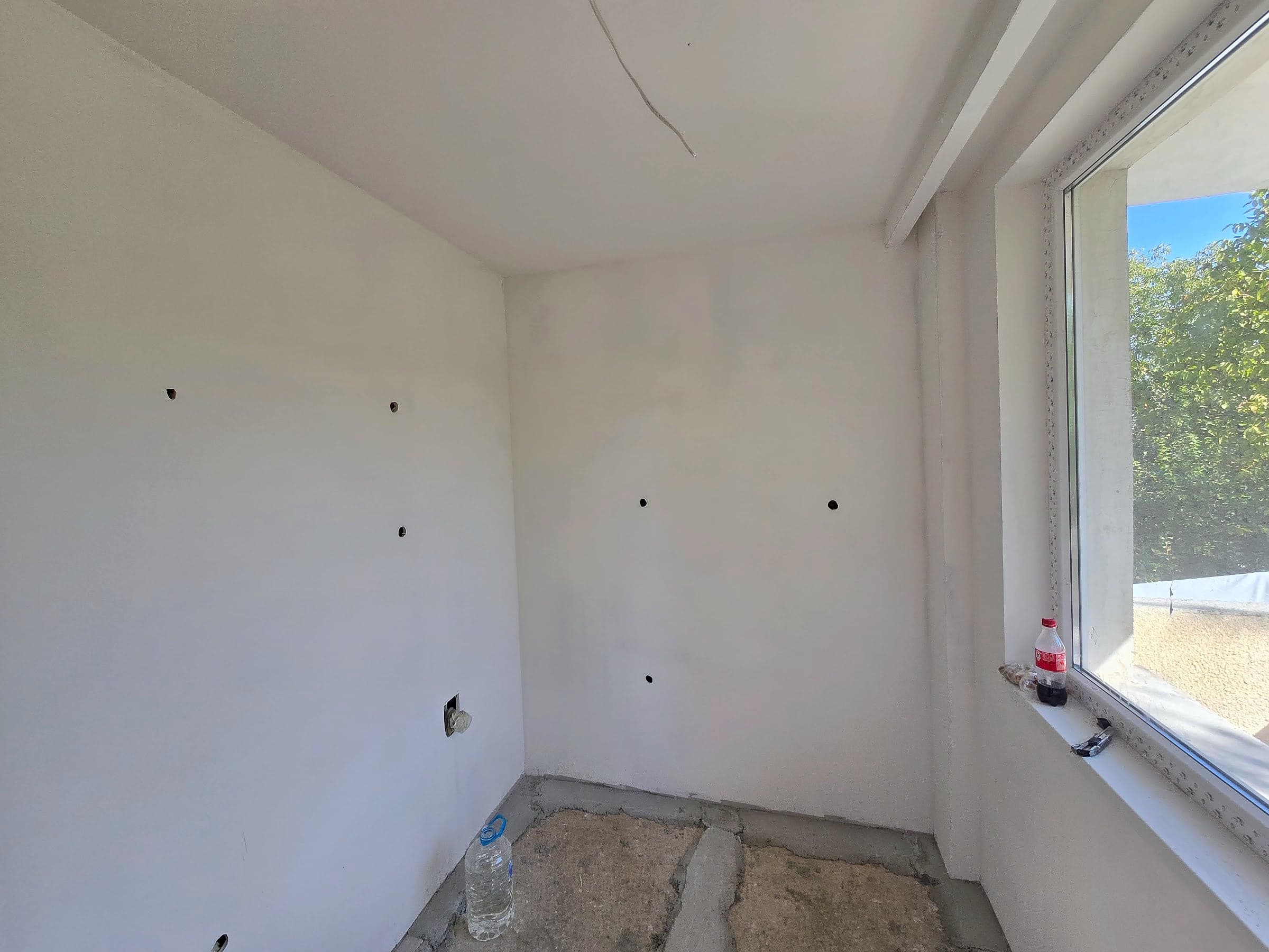 House in Bankya: skim coat, paint and a herringbone floor — The same corner before and after the renovation